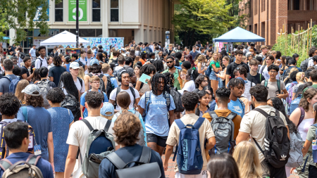 A large crowd of students on the campus of UNC-Chapel Hill near a popular student hangout called 