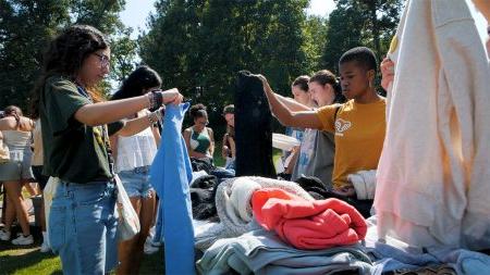 UNC Students looking through clothing.